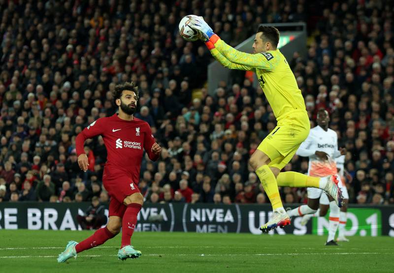 West Ham goalkeeper Lukasz Fabianski collects the ball with Liverpool attacker Mohamed Salah watching closely. Reuters