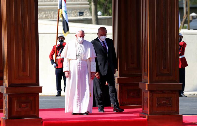 Iraqi President Barham Salih welcomes Pope Francis during an official welcome ceremony at the Presidential Palace in Baghdad. EPA