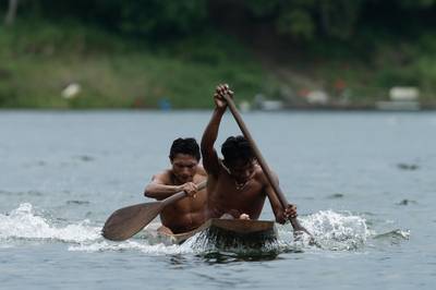 Two Guna indigenous men row in a dugout canoe during the second edition of the Panamanian indigenous games on Lake Bayano, Panama. AP