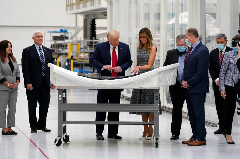 President Donald Trump looks at a piece of equipment to sign during a tour of Nasa facilities before viewing the SpaceX Demonstration Mission 2 Launch at Kennedy Space Center in Cape Canaveral, Fla. From left, second lady Karen Pence, Vice President Mike Pence, Trump, first lady Melania Trump, Michael Hawes, vice president of Lockheed Martin and Orion Project Manager, NASA Administrator Jim Bridenstine and Kennedy Space Center director Bob Cabana.  AP Photo