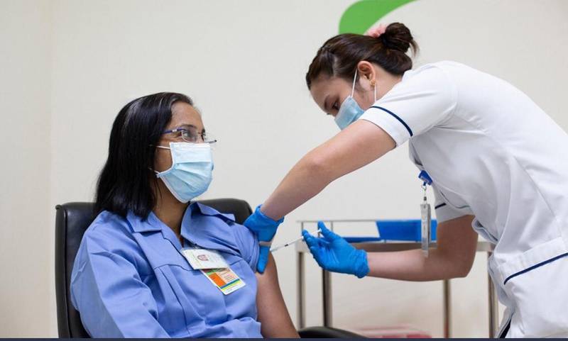 Asha Susan Philip, a nurse with Dubai Health Authority, receives the Pfizer vaccine. On Tuesday, Abu Dhabi also approved the Pfizer-BioNTech vaccine for use in the emirate.