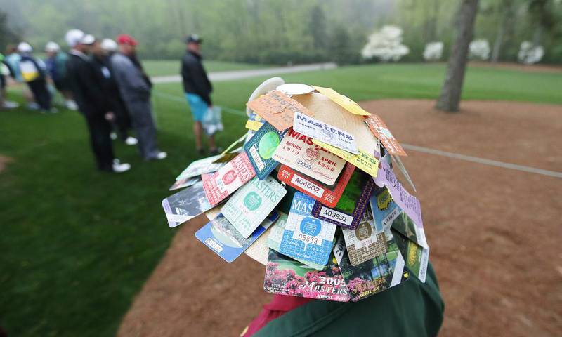A patron wears a hat covered in previous years' Masters badges along the second fairway during the first practice round at the 2014 Masters Tournament at the Augusta National Golf Club in Augusta, Georgia. The Masters Tournament will be held from Thursday to Sunday this week. Erik S Lesser / EPA