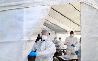 A health worker opens a free of charge Covid-19 test center on February 23, 2021 in Naumburg in the Burgenland region, eastern Germany, amid the novel coronavirus / COVID-19 pandemic. The Burgenland by far is the district with the highest number of coronavirus infections in the eastern federal state of Saxony-Anhalt. / AFP / Ronny Hartmann
