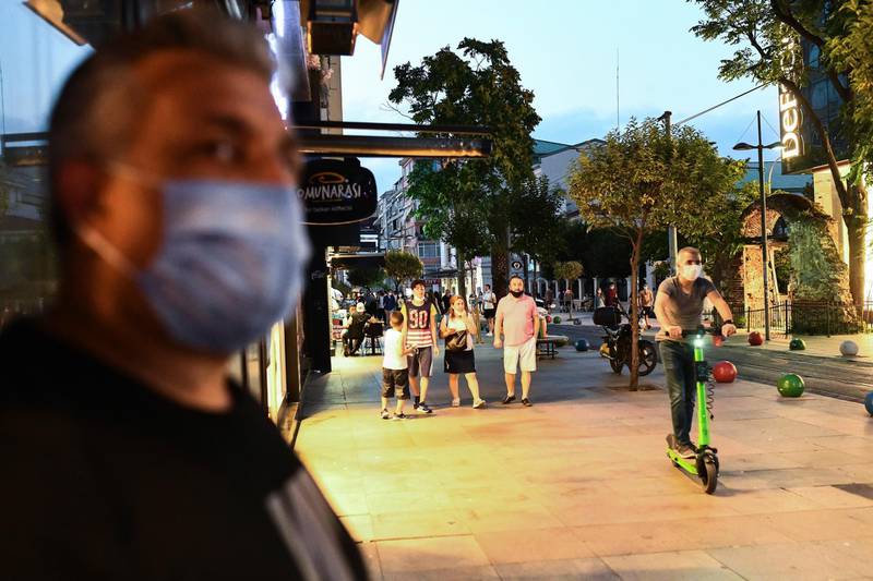Turkish people walk in Istanbul. AP Photo
