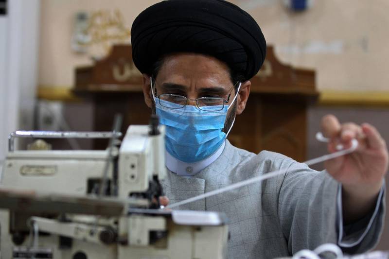 An Iraqi Shiite cleric works in the Al Sadiqeen mosque in Baghdad turned into a mask production centre.  AFP