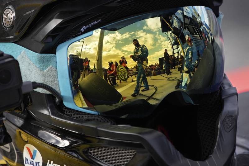 Pit crew members for driver Kyle Larson are reflected in a helmet at a Nascar Cup Series race in Las Vegas. AP