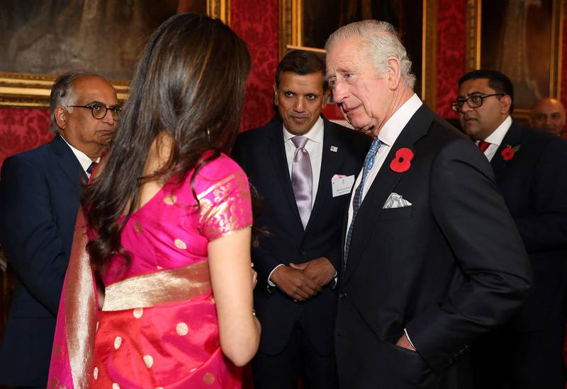 Britain's King Charles III talks with guests during a reception for the 50th anniversary of the resettlement of Asians from Uganda in the UK, at Buckingham Palace, London. AFP