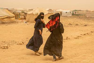 Hayat, 14, L, the daughter of a member of the pro-government forces, who used to be detained at Houthis prion, walks with her cousin around tents at a new displacement camp in Marib province.  April 4, 2021. Photo/Asmaa Waguih
