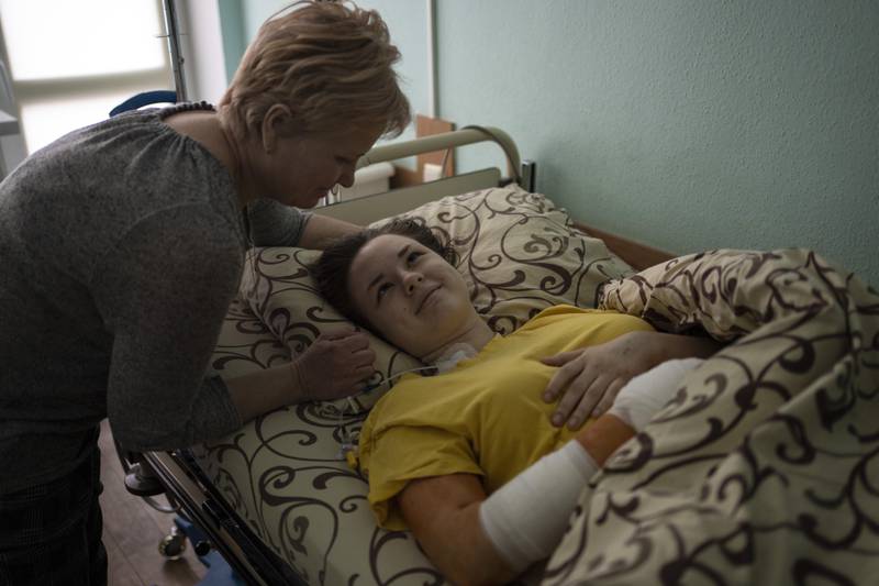 Nastya Kuzyk, 20, who was injured in an attack on Chernihiv, is comforted by her mother Svitlana, 50, as she recovers in a Kyiv hospital. AP