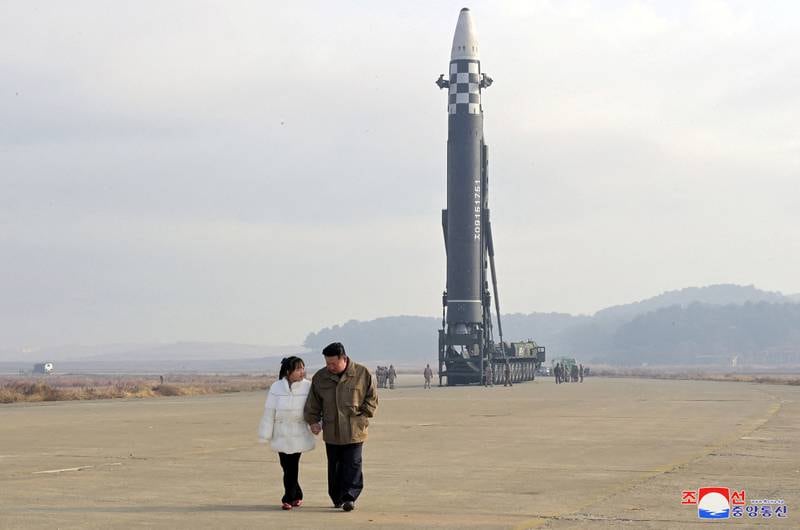 North Korean leader Kim Jong-un and a girl purported to be his daughter attend the launch of a Hwasongpho-17 ballistic missile. Reuters