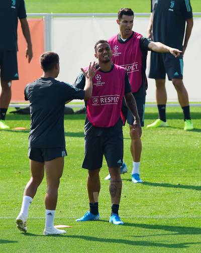 Juventus' Danilo talking to Paulo Dybala during, with Cristiano Ronaldo in the background. Reuters