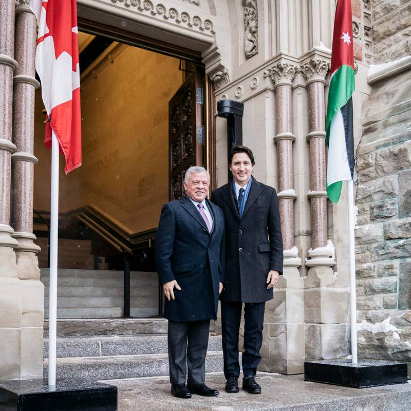 King Abdullah and Mr Trudeau stand for a photo outside the Canadian Parliament. AFP