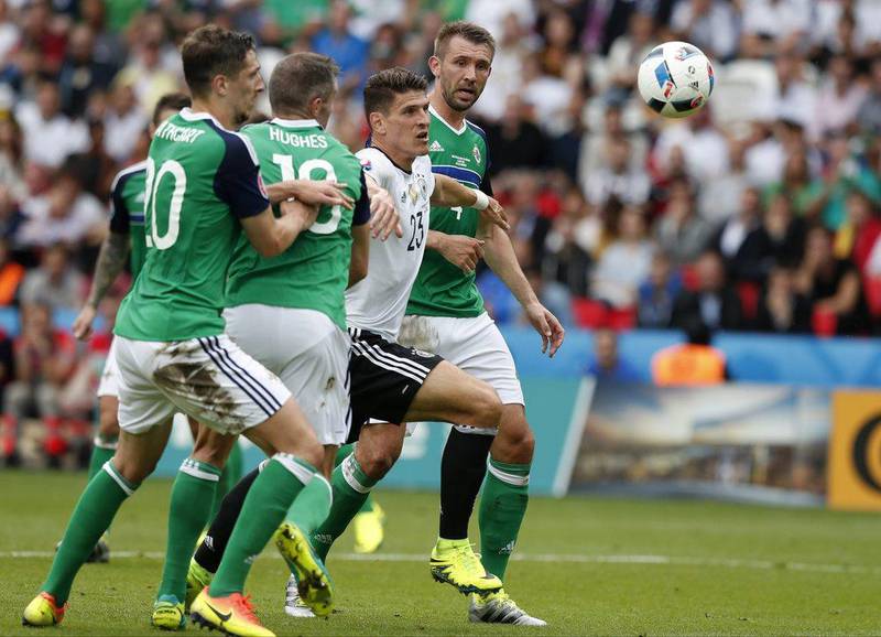Germany's Mario Gomez, second from right, eyes the ball during the Euro 2016 Group C match between Northern Ireland and Germany at the Parc des Princes stadium in Paris, France, Tuesday, June 21, 2016. (AP/Francois Mori)