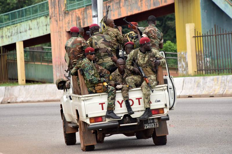 Soldiers travel through Conakry. AFP