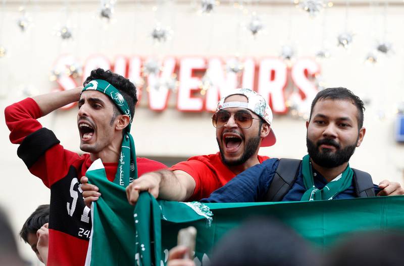 Saudi Arabian soccer fans chant slogans on the eve of the opener of the 2018 soccer World Cup in downtown Moscow, Russia, Wednesday, June 13, 2018. (AP Photo/Darko Bandic)