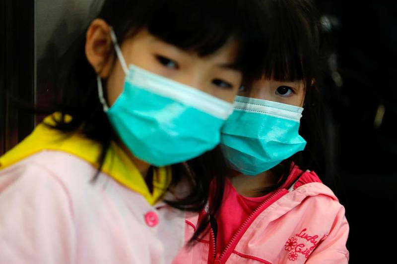 Children wear masks to prevent an outbreak of a new coronavirus at the Hong Kong West Kowloon High Speed Train Station, in Hong Kong, China. Reuters