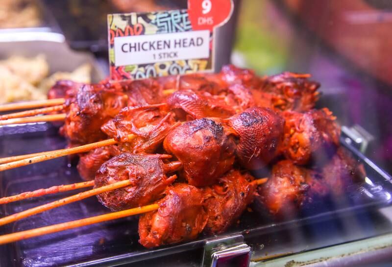 'Helmet' is barbecued chicken head. Similar to jumbo isaw and adidas in marinade and dipping sauce, but not as popular. This is the version served at Kabayan Zone.