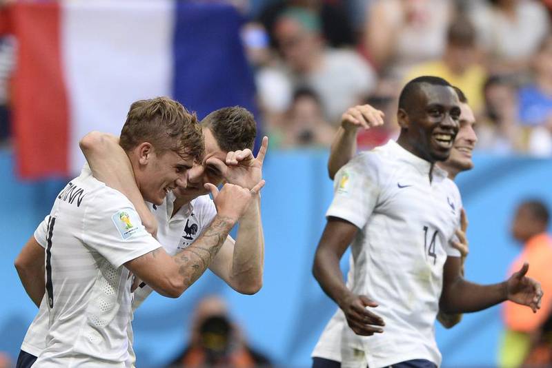 France forward Antoine Griezmann, left, celebrates with defender Laurent Koscielny, second left, and midfielder Blaise Matuidi after their second goal against Nigeria on Monday at the 2014 World Cup. Franck Fife / AFP