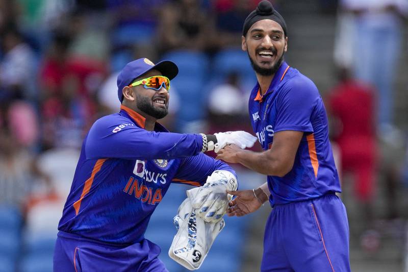 Arshdeep Singh, right, celebrates with wicket-keeper Rishabh Pant after taking the wicket of Kyle Mayers. AP