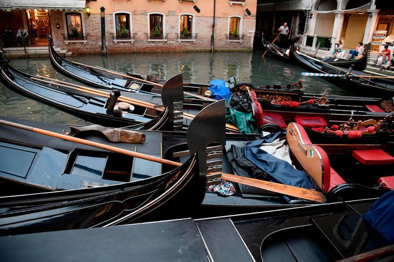 Gondolas are pictured on a canal on September 7, 2018 in Venice. (Photo by Filippo MONTEFORTE / AFP)