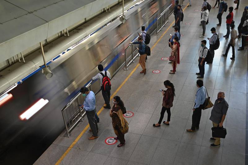 Commuters wait to board the metro at a station on June 7, 2021.