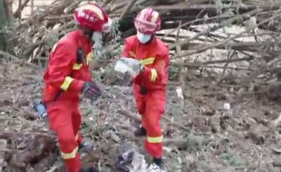 A screengrab from video by state broadcaster CCTV) shows rescue workers searching the crash site. AFP
