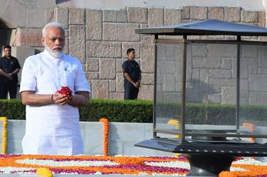 Narendra Modi pays tribute at Mahatma Gandhi's memorial ahead of his swearing-in as the 16th prime minister of India on Thursday. EPA    