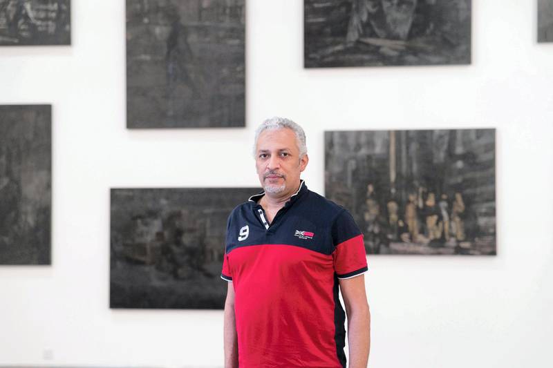 DUBAI, UNITED ARAB EMIRATES - SEPTEMBER 27, 2018. Mohammed Kazem infront of his series "Even the Shade does not Belong to Them" at his solo show "A Prime Activity", in Gallery Isabelle van den Eynde. The show focuses on his paintings – a relatively unknown aspect of his practice. Kazem has been painting since his late teens and early 20s, went on to win the first prize in painting at Muscat Youth Biennial in 1990 and loved the surface so much that he remained consciously aware to the inspiration coming from the medium itself.While painting remained a major aspect of Kazem’s early practice, now more than 30 years later, he is still fascinated by collecting and documenting information about unimportant objects and traces of our present within a particular environment. In his monograph published in 2013, Hassan Sharif wrote, “The meaning or purpose of his [Kazem’s] paintings lies in the life of the colours and the ways they can be put to use, not in the painted objects themselves.” (Photo by Reem Mohammed/The National)Reporter: Melissa GronlundSection: AC