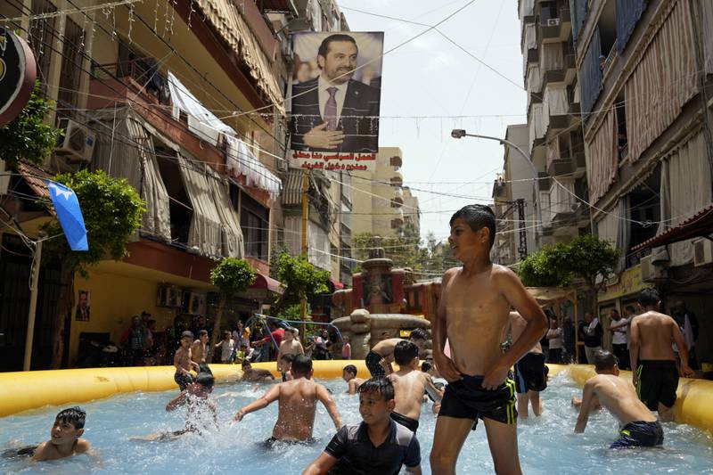 Mr Hariri, seen in poster, suspended his participation in Lebanese politics last year and called on his supporters to boycott Sunday’s vote. AP