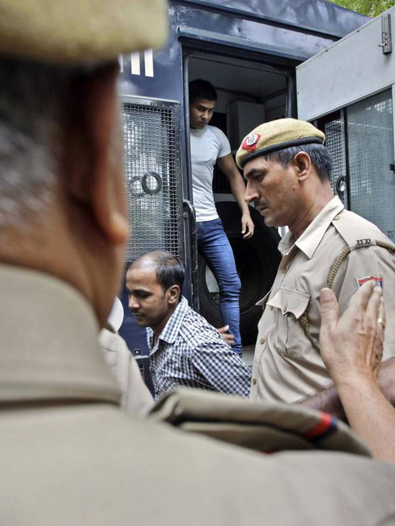 Mukesh Singh, centre, and Vinay Sharma, two of the four men sentenced to death for raping and torturing a young woman on a moving bus in New Delhi, arrive at the Delhi High Court today as appeals against their sentence and verdict begins. Tsering Topgyal / AP Photo