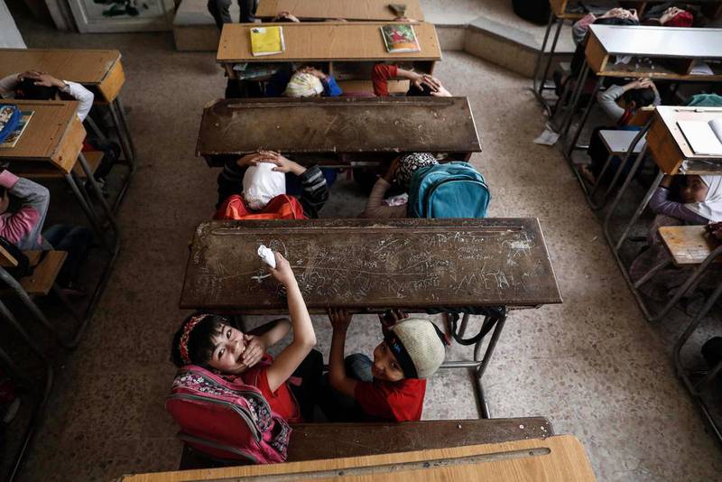Syrian school children learn how to protect themselves during a war safety awareness class on the northeastern outskirts of the capital Damascus. Sameer Al Doumy / AFP Photo