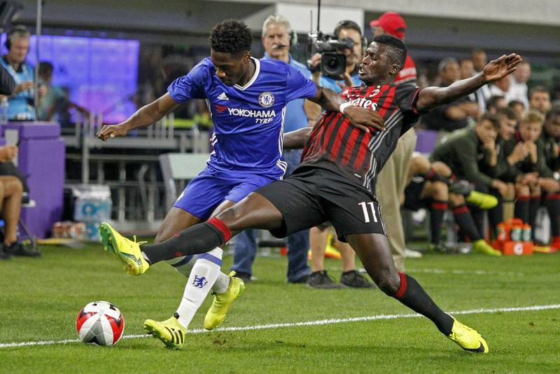 Chelsea’s Ola Aina, left, battles with AC Milan’s Niang Mbaye for the ball. Bruce Kluckhohn / AP Photo