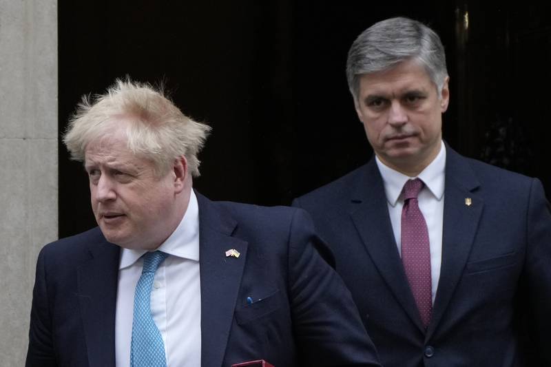 British Prime Minister Boris Johnson leaves 10 Downing Street with the Ukrainian ambassador to the UK, Vadym Prystaiko, on Wednesday. AP