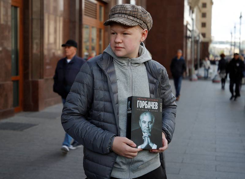 A mourner holds a copy of 'Gorbachev: His Life and Times' outside the hall in the Russian capital. Reuters