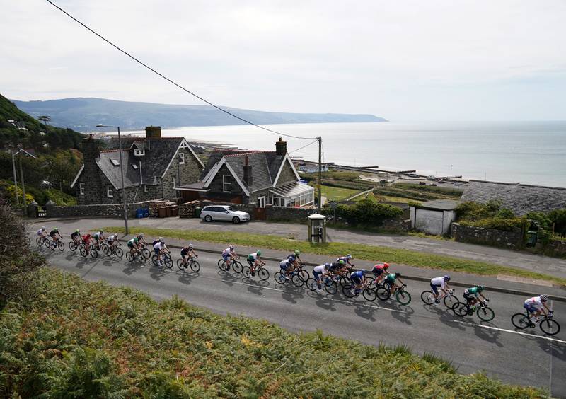 The peloton passes through Barmouth in Wales during Stage 4 of the Tour of Britain on Wednesday September 8, 2021. PA