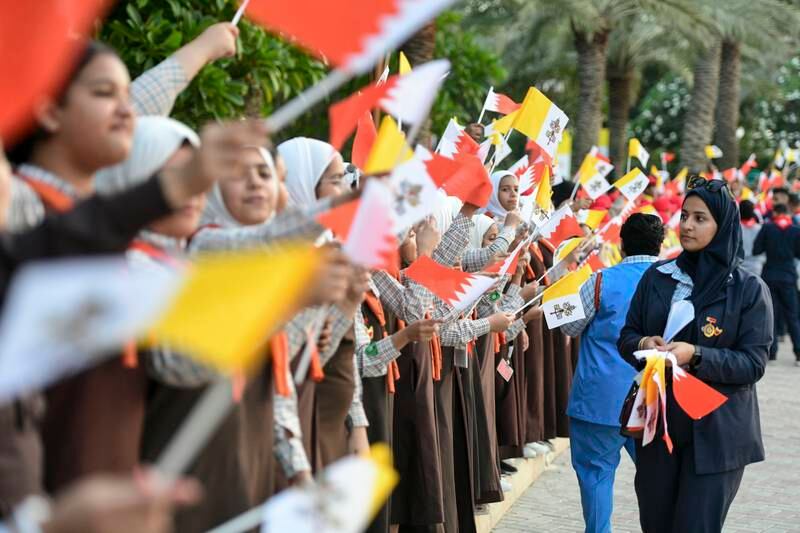 Schoolchildren prepare to welcome the Pope on the grounds of Sakhir Palace. Khushnum Bhandari / The National