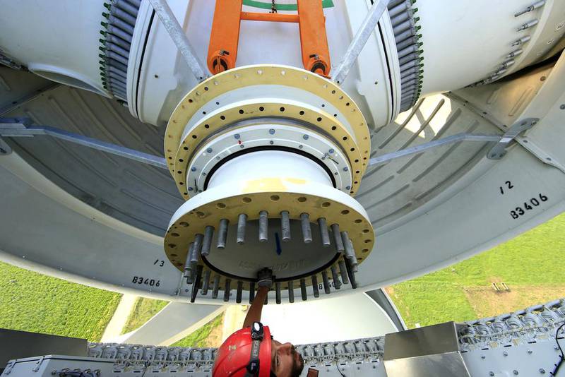 France is heavily reliant on nuclear energy, accounting for 75 per cent of its electricity. Above, a worker inside the rotor hub of an E-70 wind turbine being installed at a wind farm in Meneslies. Benoit Tessier / Reuters