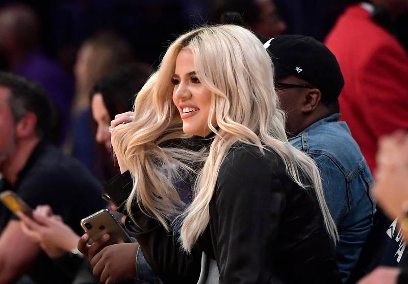 FILE - In this Jan. 13, 2019, file photo, Khloe Kardashian watches during the second half of an NBA basketball game between the Los Angeles Lakers and the Cleveland Cavaliers in Los Angeles. Kardashian says she had tested positive for the coronavirus.  The reality star confirmed her previous diagnosis in a Wednesday, Oct. 28, 2020, sneak peek clip of â€œKeeping Up with the Kardashians.â€ The bedridden Kardashian spoke in the video with a hoarse voice.  (AP Photo/Mark J. Terrill, File)