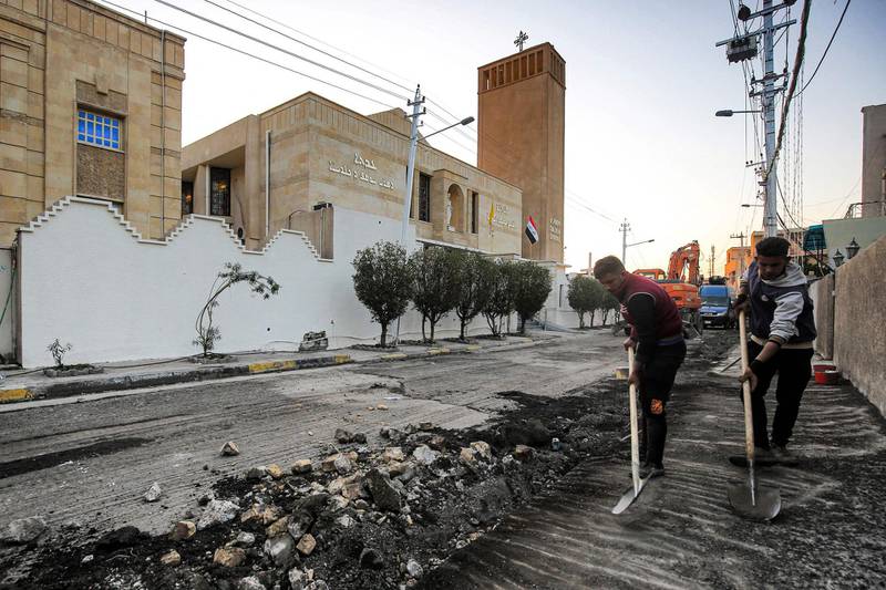 Municipal workers pave the road outside the Chaldean Catholic Church of St Joseph in preparation for the Pope's visit to Baghdad. AFP