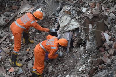 Rescue workers search for survivors in the rubble of a collapsed five-storey apartment building in Mahad, a town about 170 kilometres south of India's financial capital Mumbai.  AFP