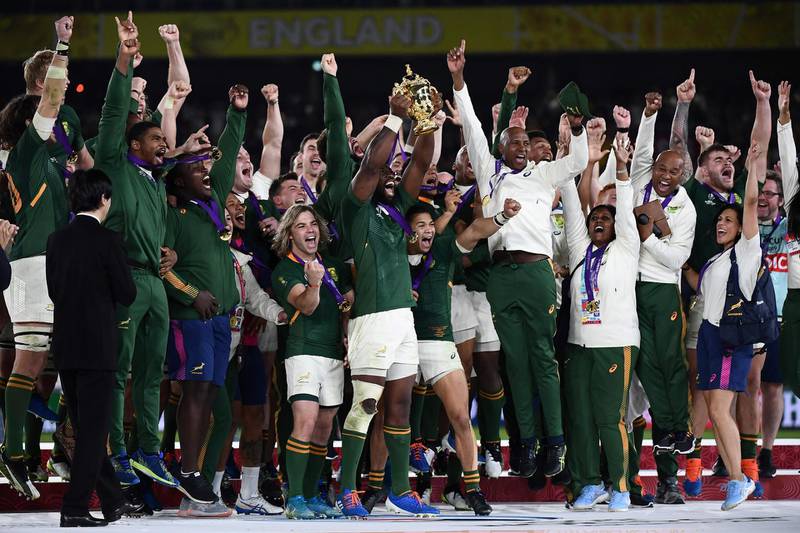 South Africa's flanker Siya Kolisi (C) lifts the Webb Ellis Cup as they celebrate winning the Japan 2019 Rugby World Cup final match between England and South Africa at the International Stadium Yokohama in Yokohama. AFP