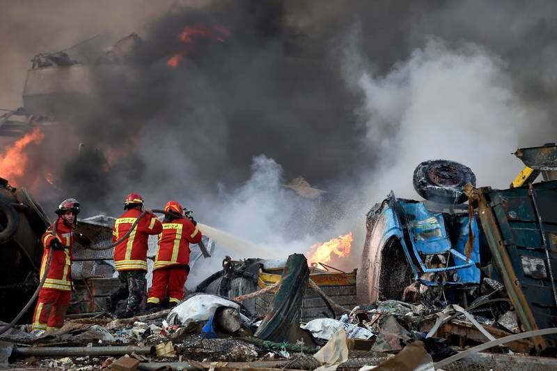 Firefighters try to extinguish flames after a large explosion rocked the harbour area of Beirut, Lebanon, on August 4, 2020. EPA