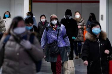 People wearing protective face masks walk inside a subway station in Shanghai, China. Reuters