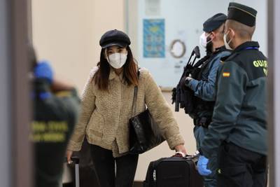 A passenger from Beijing leaves the terminal after landing at Adolfo Suarez Madrid-Barajas airport on New Year's Eve.  AFP