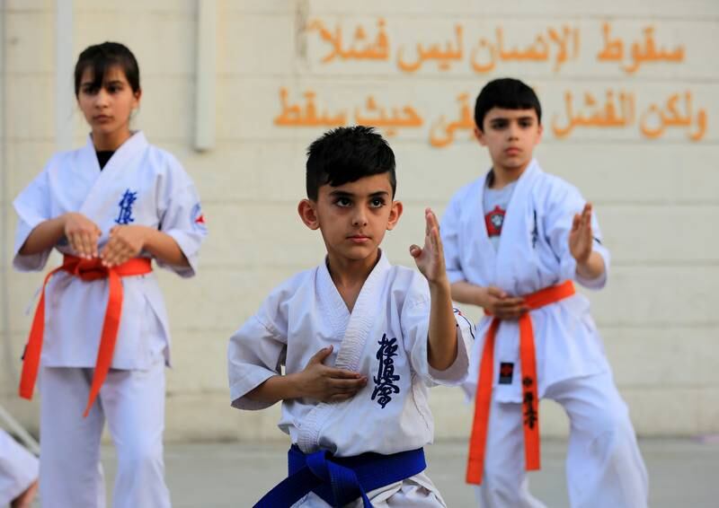 Young Iraqis takes part in a karate lesson at a sports club in Baghdad's Karada district. All photos: EPA