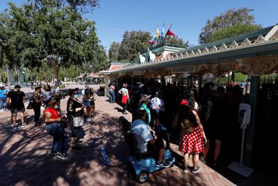 People wait to get inside Disneyland Park on its reopening day amidst the coronavirus disease (COVID-19) outbreak, in Anaheim, California, U.S., April 30, 2021.  REUTERS/Mario Anzuoni