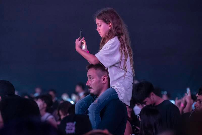 A young fan in attendance at the K-pop concert. 