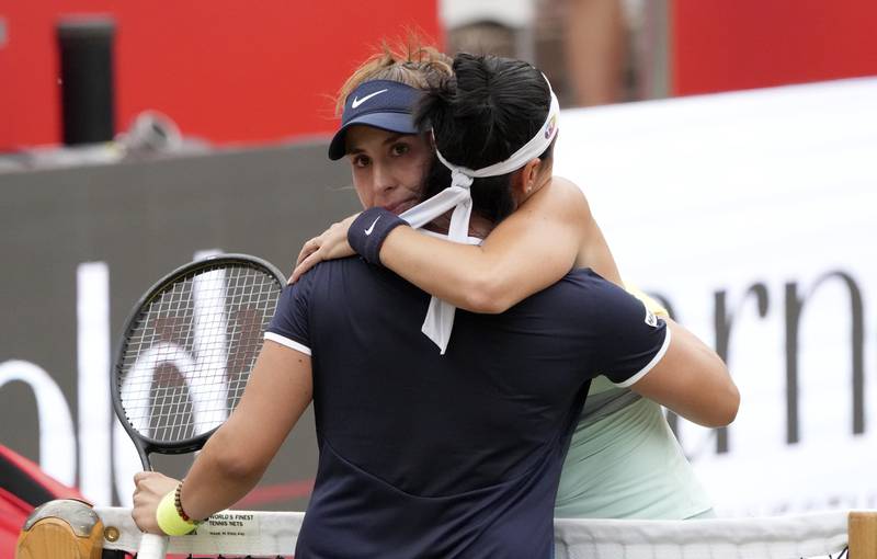 Ons Jabeur hugs Belinda Bencic after the match. AFP