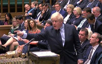 Britain's Prime Minister Boris Johnson gestures toward the opposition benches as he stands a the dispatch box and speaks in the House of Commons in London. PRU / AFP