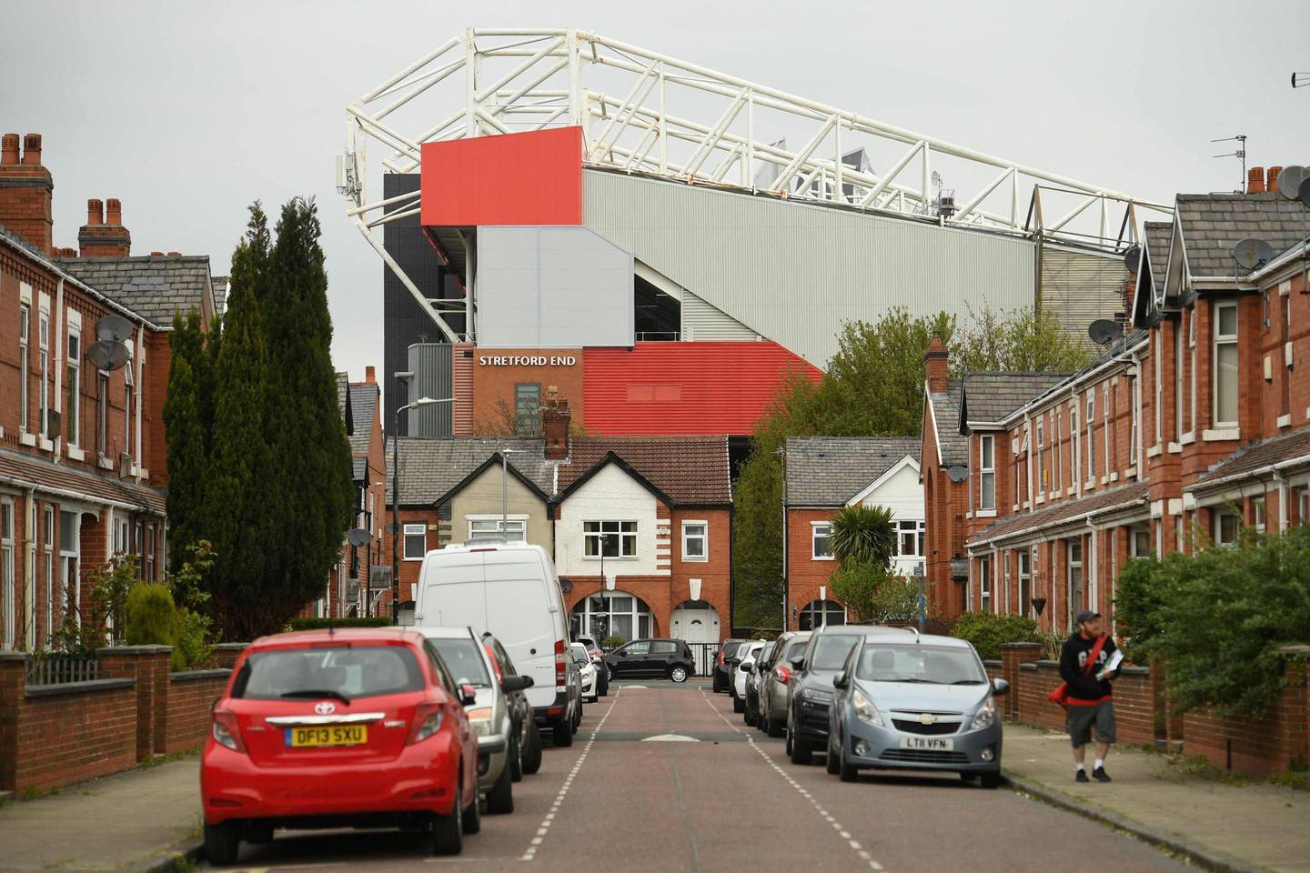 Manchester United's Old Trafford stadium rises above the nearby residential streets in Manchester, northwest England on April 21, 2021.  The proposed European Super League (ESL) appeared dead in the water today after all six English clubs withdrew following a furious backlash from fans and threats from football authorities. / AFP / Oli SCARFF
